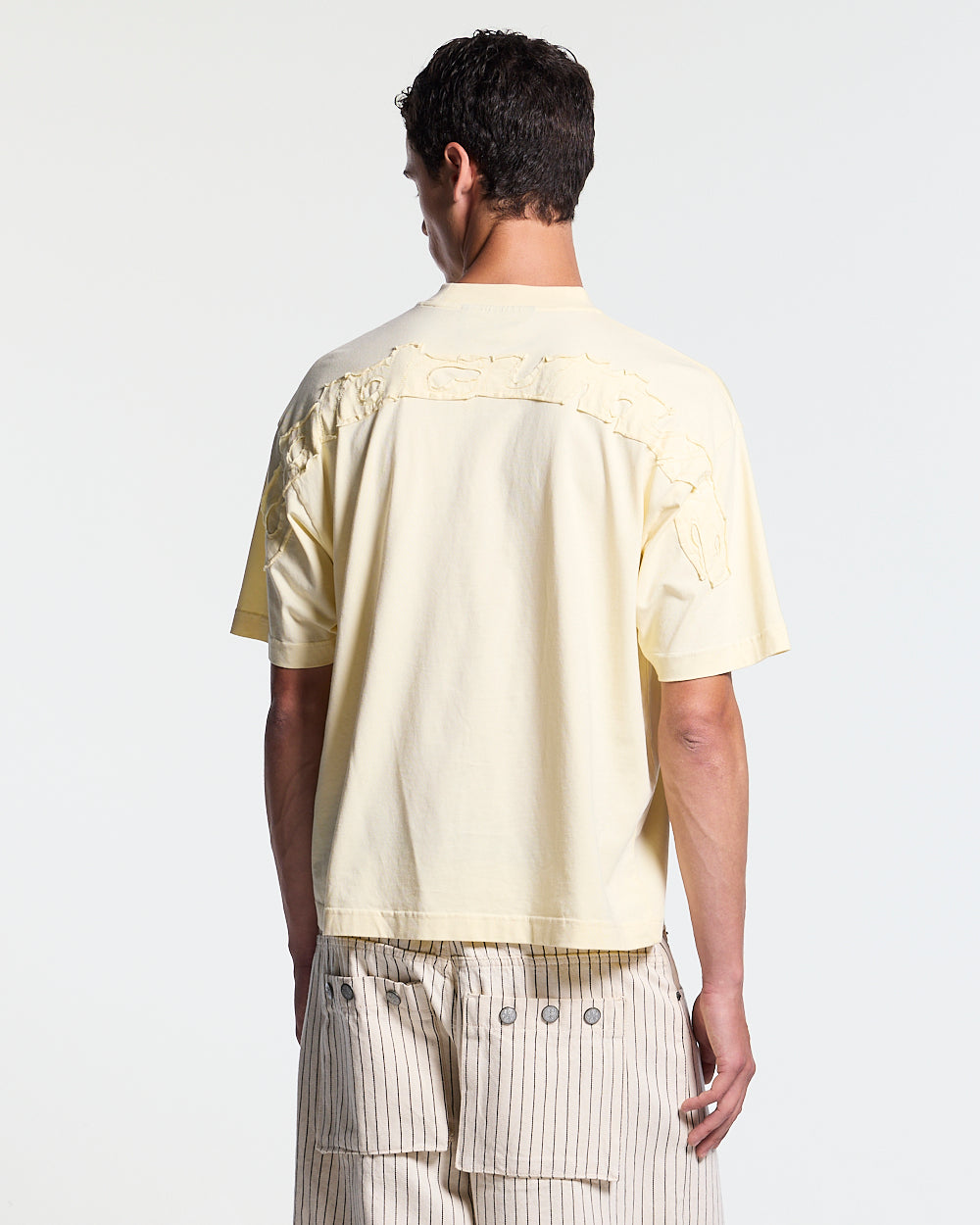 DISTRESS CURVED TEE YELLOW - pale yellow distressed tee, back view on male model - Cold Culture #man
