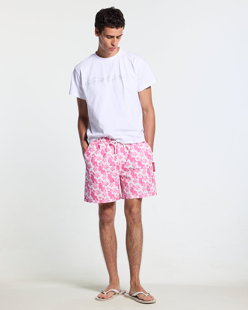 ALOHA SWIMSHORTS PINK - pink floral swim shorts, front view on male model - Cold Culture #man