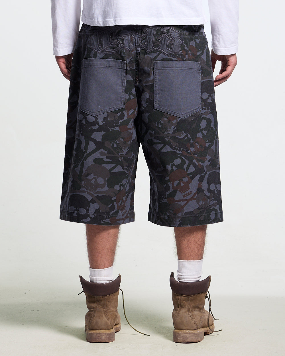 NIGHTSKULL SHORTS GREY - grey skull camo shorts, back view on male model - Cold Culture