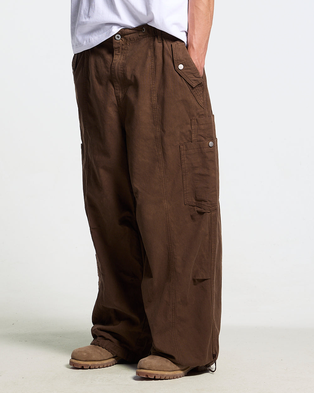 SOLID CARGO PANTS BROWN - brown cargo pants, side view on male model - Cold Culture