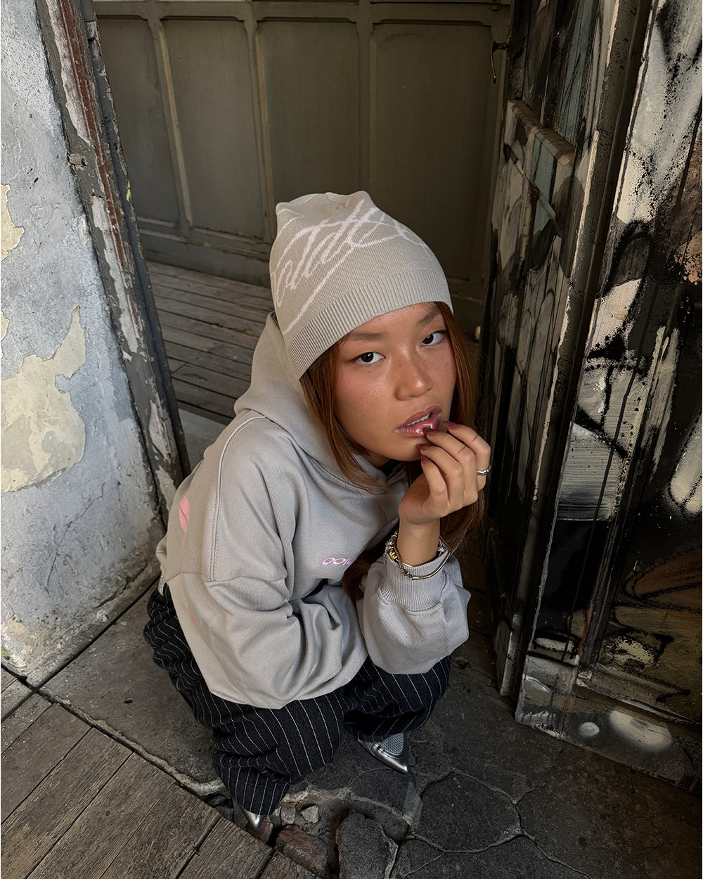 SCRIPT BEANIE BEIGE - beige script knit beanie, street style shot - Cold Culture #woman
