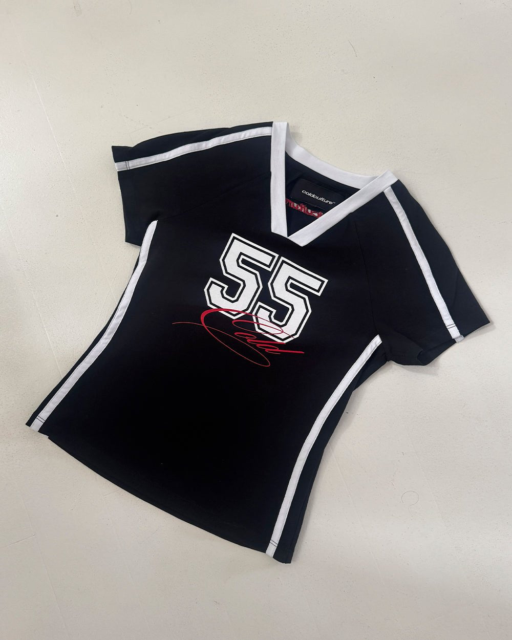 BANDAL BABY TEE BLACK - black varsity baby tee, flat lay - Cold Culture