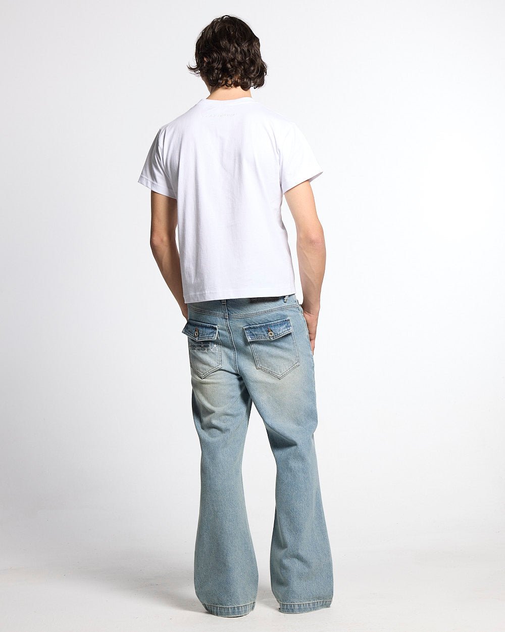 BLURRED V5 BOOTCUT PANTS LIGHT DENIM - light wash denim bootcut pants, back view on male model - Cold Culture #man