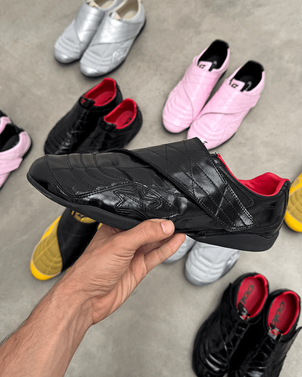 COLD HOOK SNEAKER BLACK - black velcro strap sneakers, detail in hand - Cold Culture