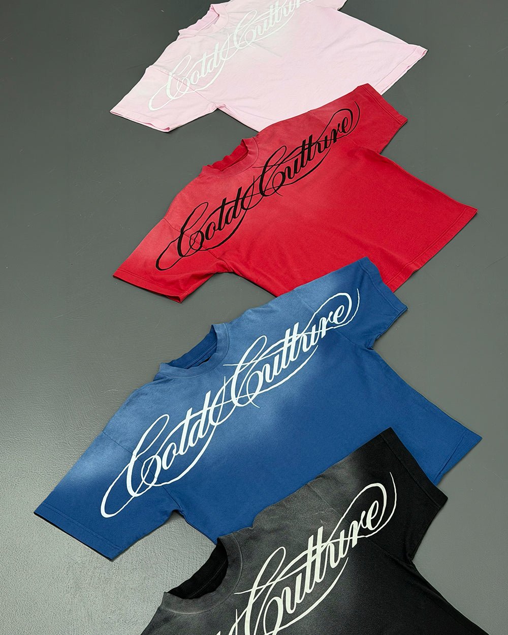 CROSSED SCRIPT TEE BLUE - washed blue tee, flat lay with matching pieces - Cold Culture