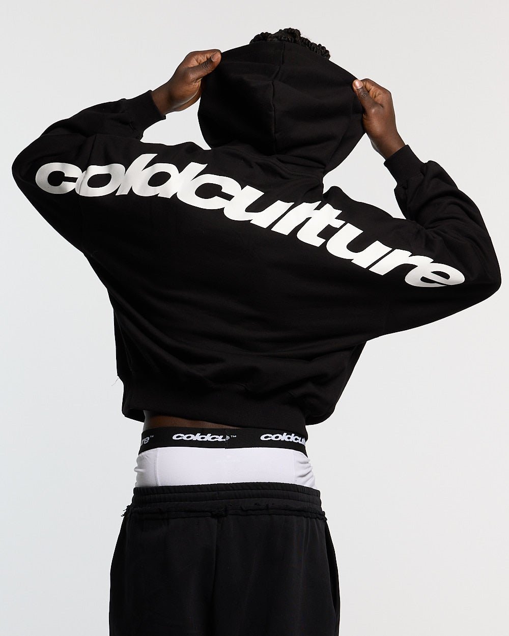 CURVED HOODIE BLACK AND WHITE - black oversized hoodie, back view on male model - Cold Culture