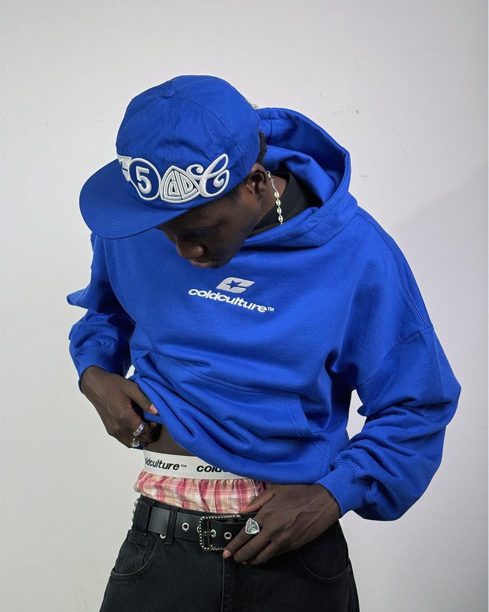 CURVED HOODIE BLUE - royal blue logo print hoodie, front view on male model - Cold Culture