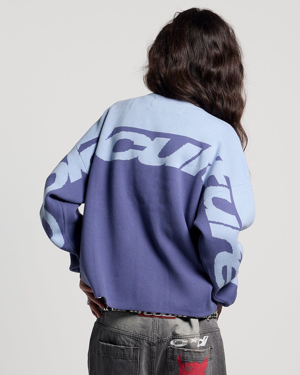 CURVED KNIT BLUE - blue two-tone knit sweater, back view on female model - Cold Culture #woman