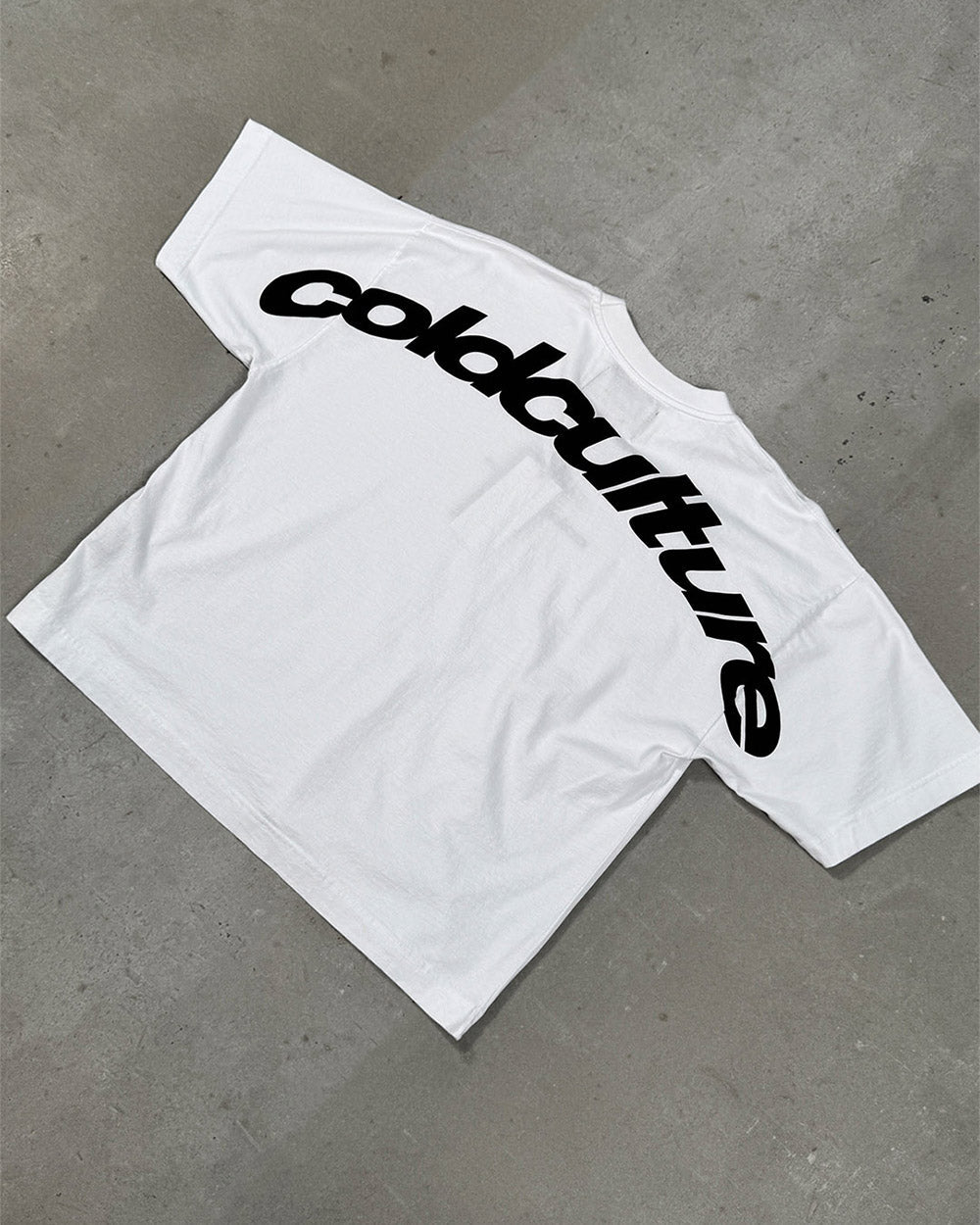 CURVED TEE WHITE - white oversized tee, flat lay - Cold Culture