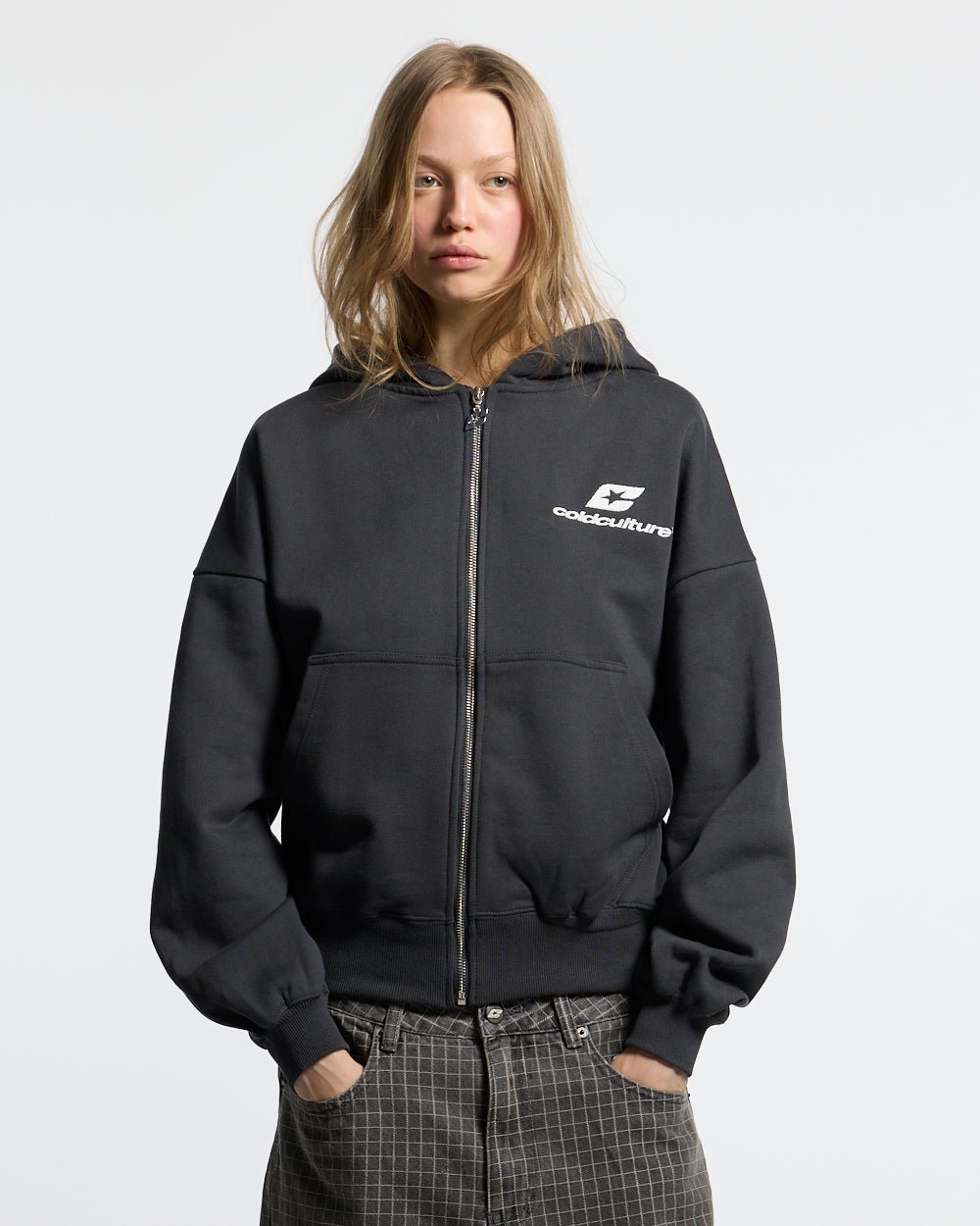 CURVED ZIP HOODIE INDIA INK - black logo print zip hoodie, front view on female model - Cold Culture #woman
