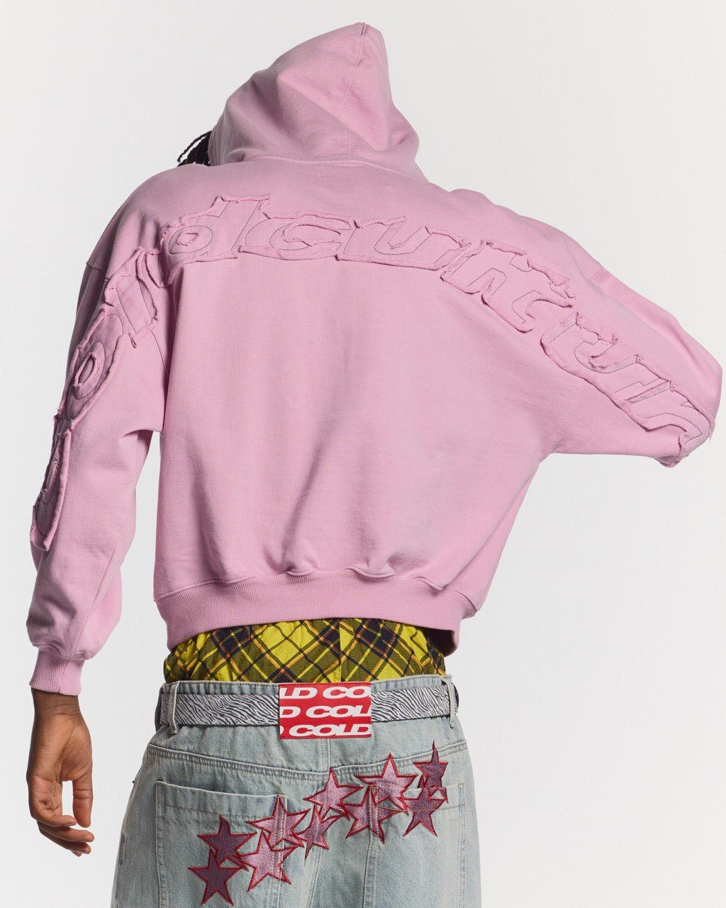 DISTRESS CURVED HOODIE PINK - pink distressed hoodie, back view on male model - Cold Culture
