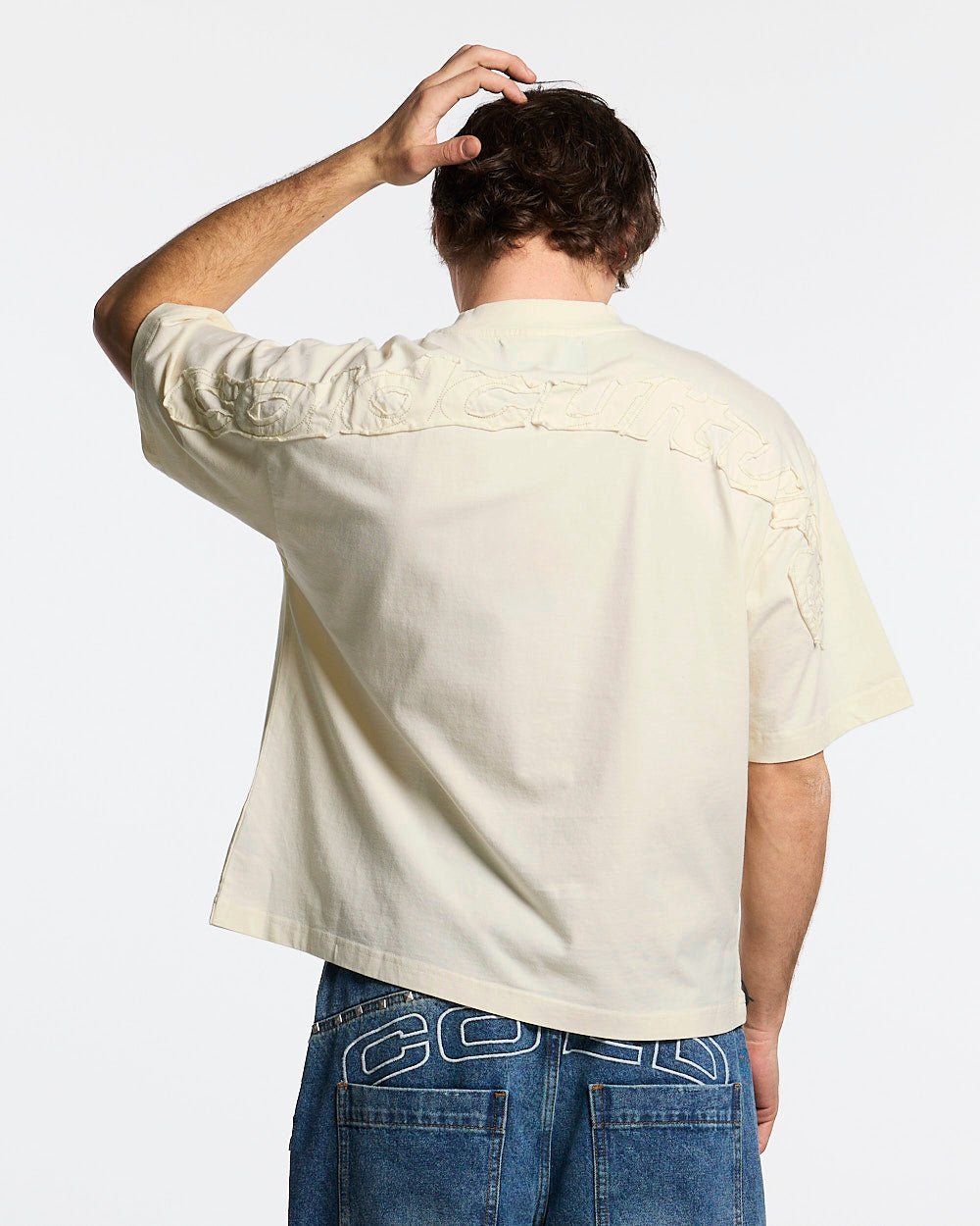 DISTRESS CURVED TEE CREAM - cream distressed tee, back view on male model - Cold Culture #man
