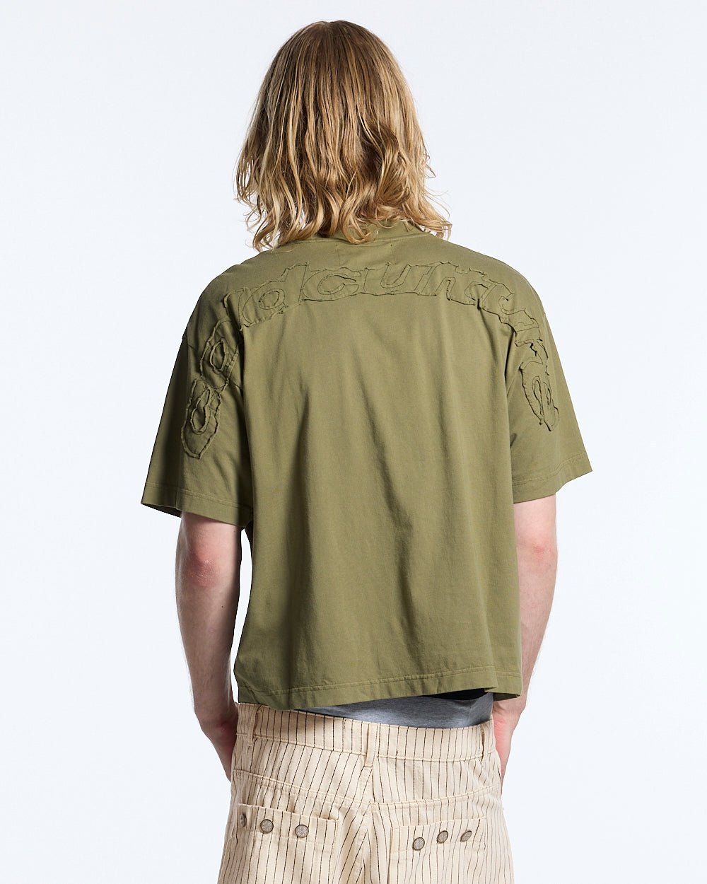 DISTRESS CURVED TEE GREEN - olive green boxy tee, back view on male model - Cold Culture #man