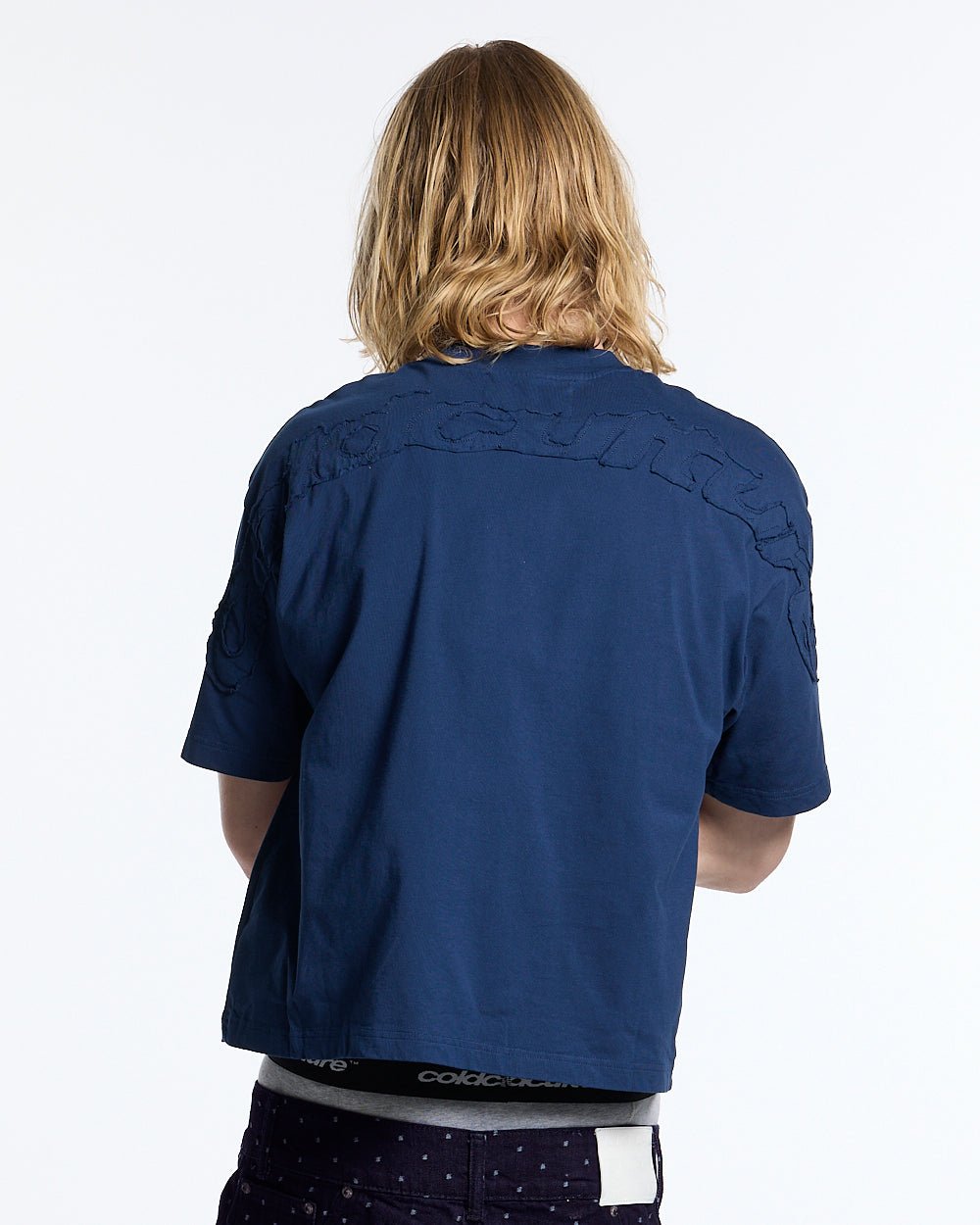 DISTRESS CURVED TEE NAVY - navy blue boxy tee, back view on male model - Cold Culture #man