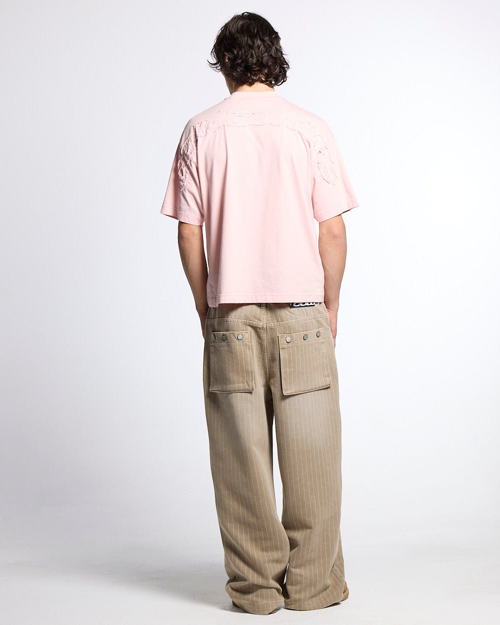 DISTRESS CURVED TEE PINK - pink distressed logo tee, back view on male model - Cold Culture #man