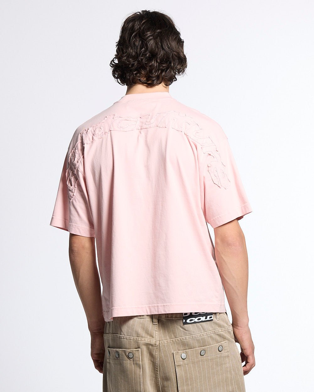 DISTRESS CURVED TEE PINK - pink distressed logo tee, back view on male model - Cold Culture #man