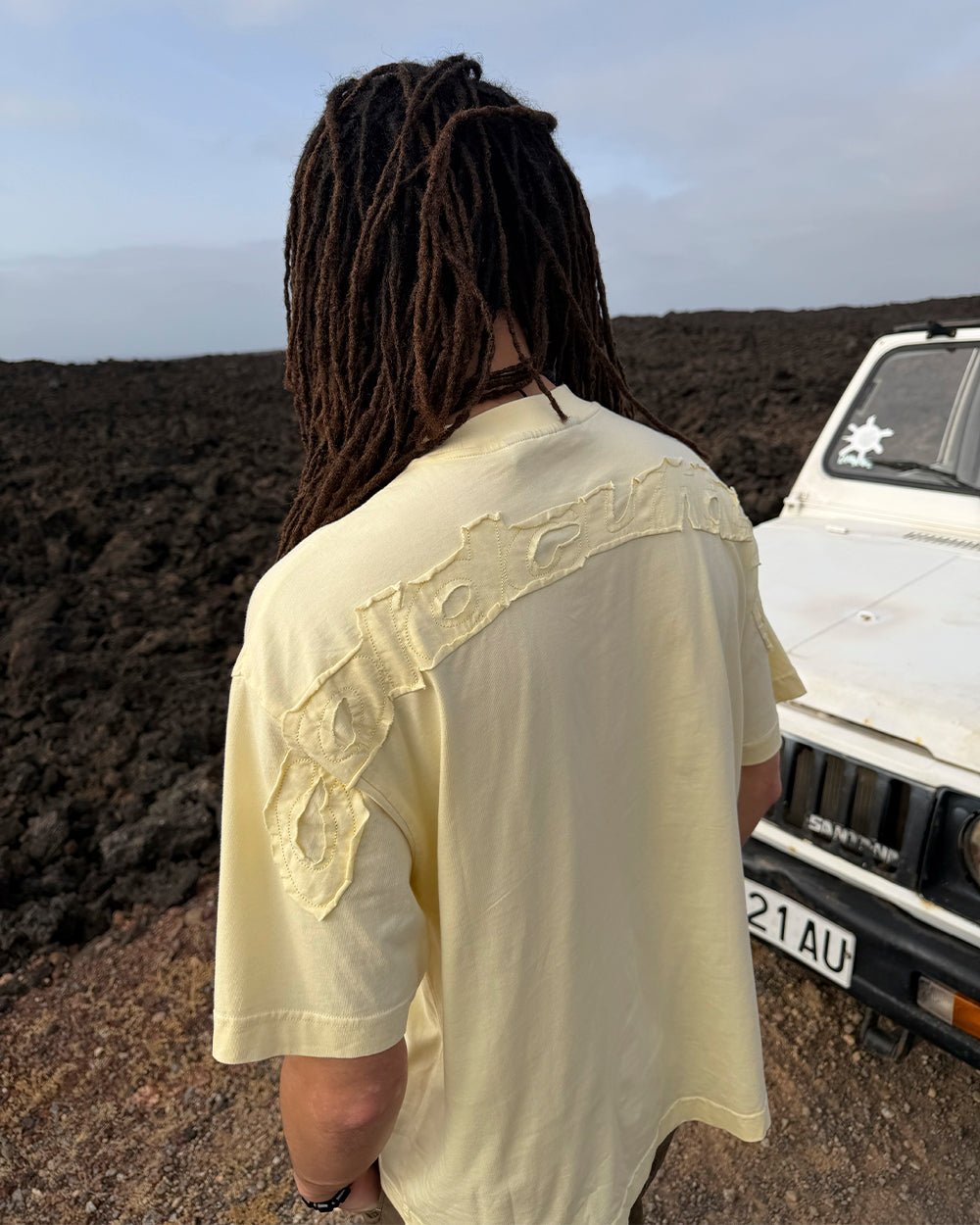 DISTRESS CURVED TEE YELLOW - pale yellow distressed tee, street style shot - Cold Culture