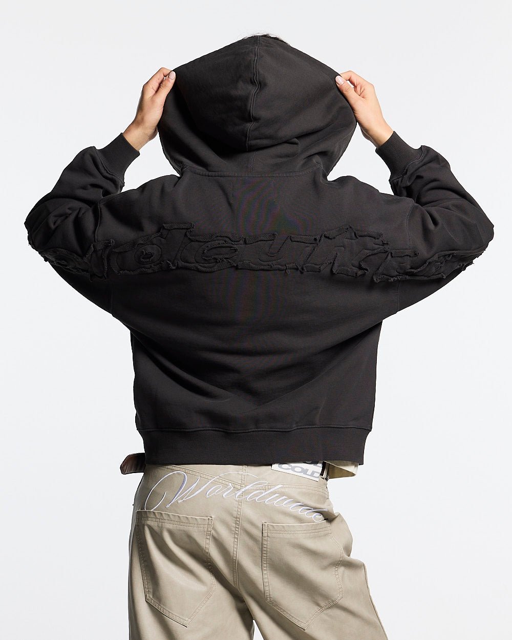 DISTRESS CURVED ZIP HOODIE DARK GREY - dark grey distressed zip-up hoodie, back view on female model - Cold Culture #woman