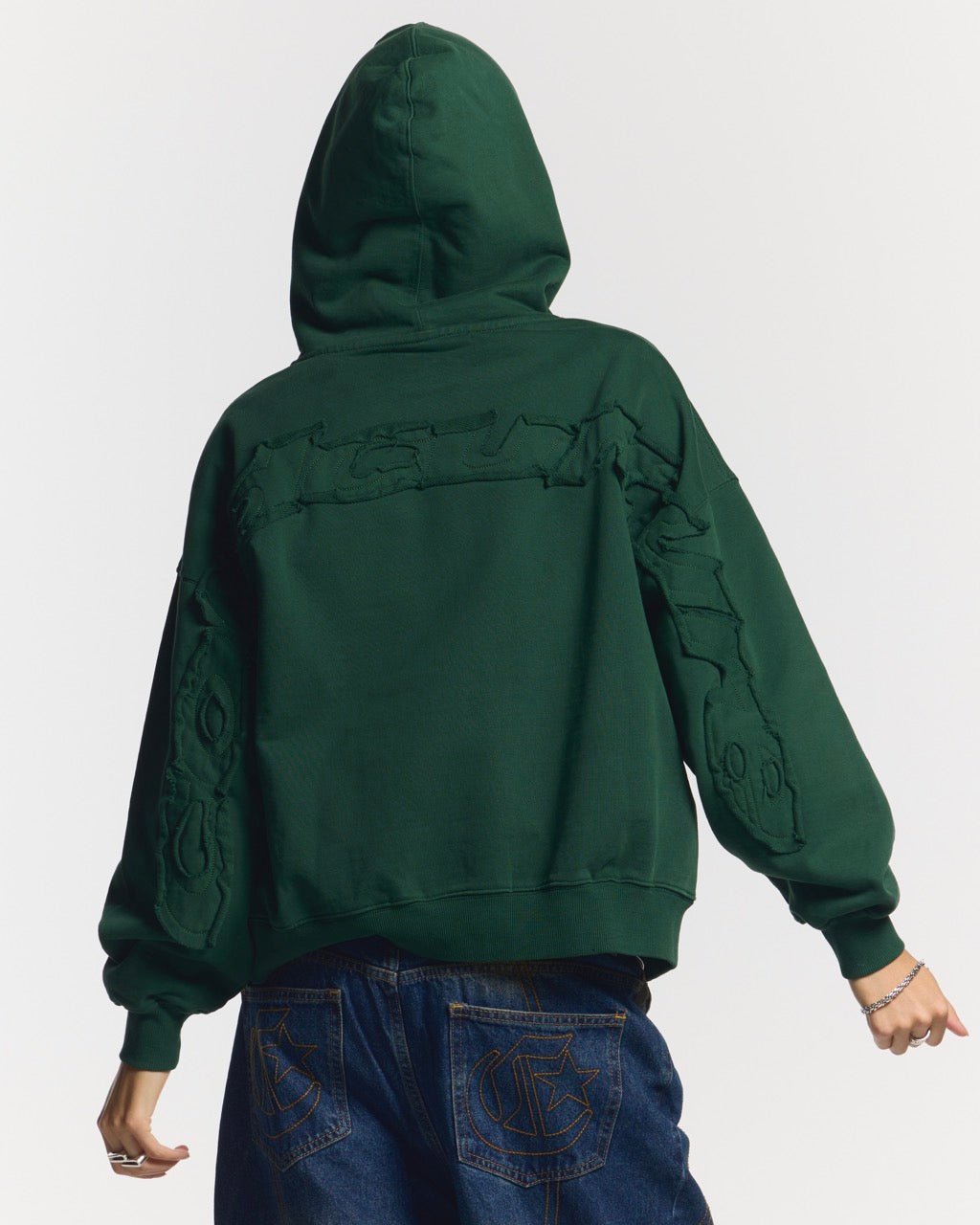 DISTRESS CURVED ZIP HOODIE GREEN - green distressed zip-up hoodie, back view on female model - Cold Culture #woman