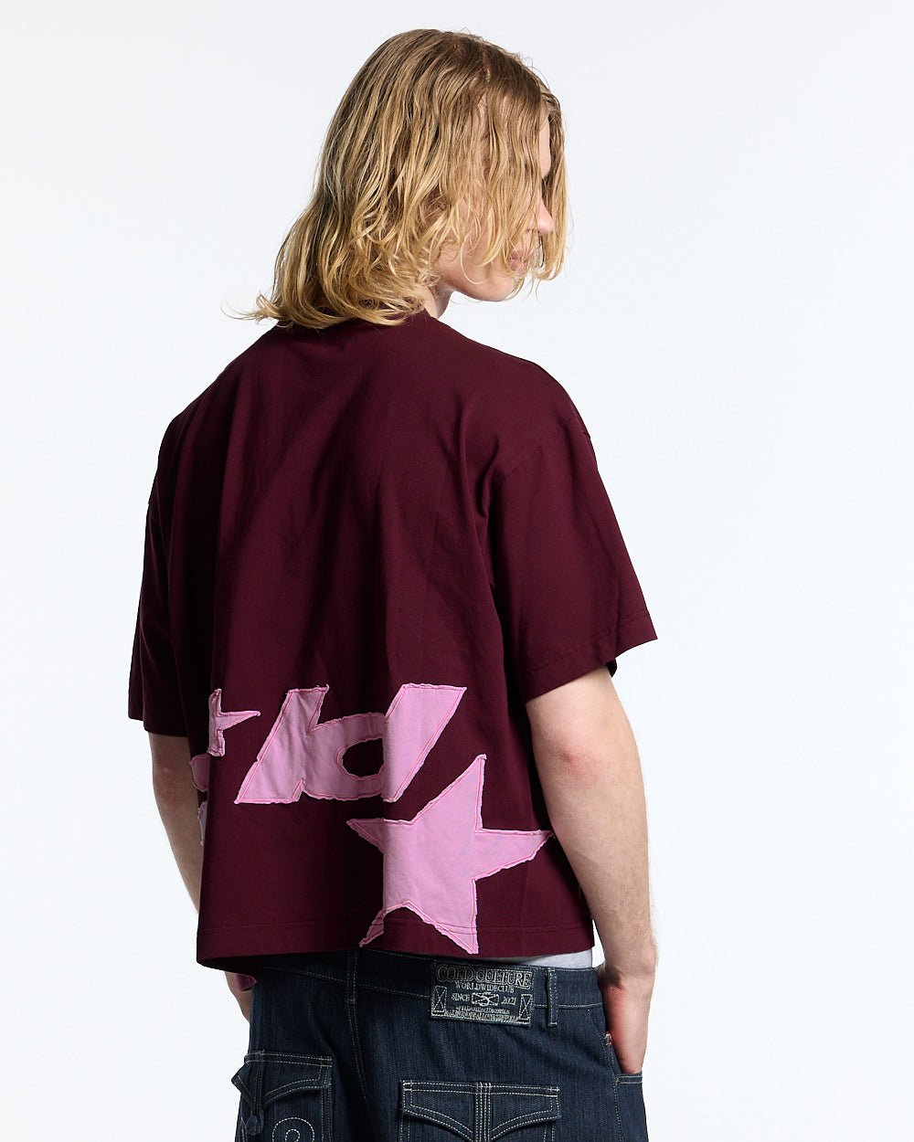 DISTRESS DEFENSE TEE BURGUNDY - burgundy graphic print tee, back view on male model - Cold Culture #man