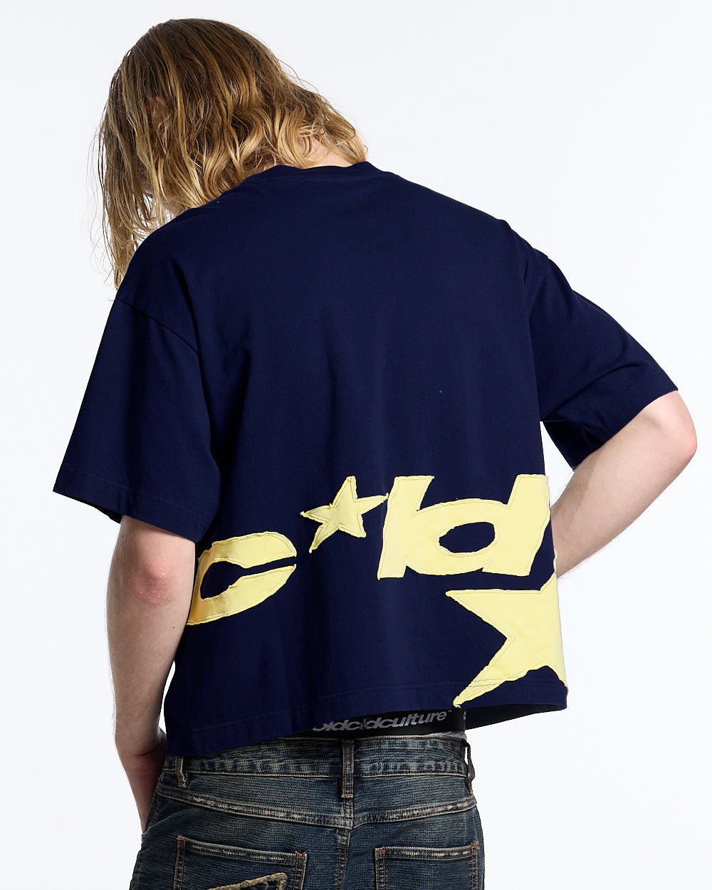 DISTRESS DEFENSE TEE NAVY - navy blue graphic print tee, back view on male model - Cold Culture #man
