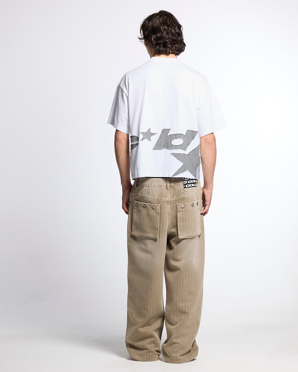 DISTRESS DEFENSE TEE WHITE - white graphic print tee, back view on male model - Cold Culture #man