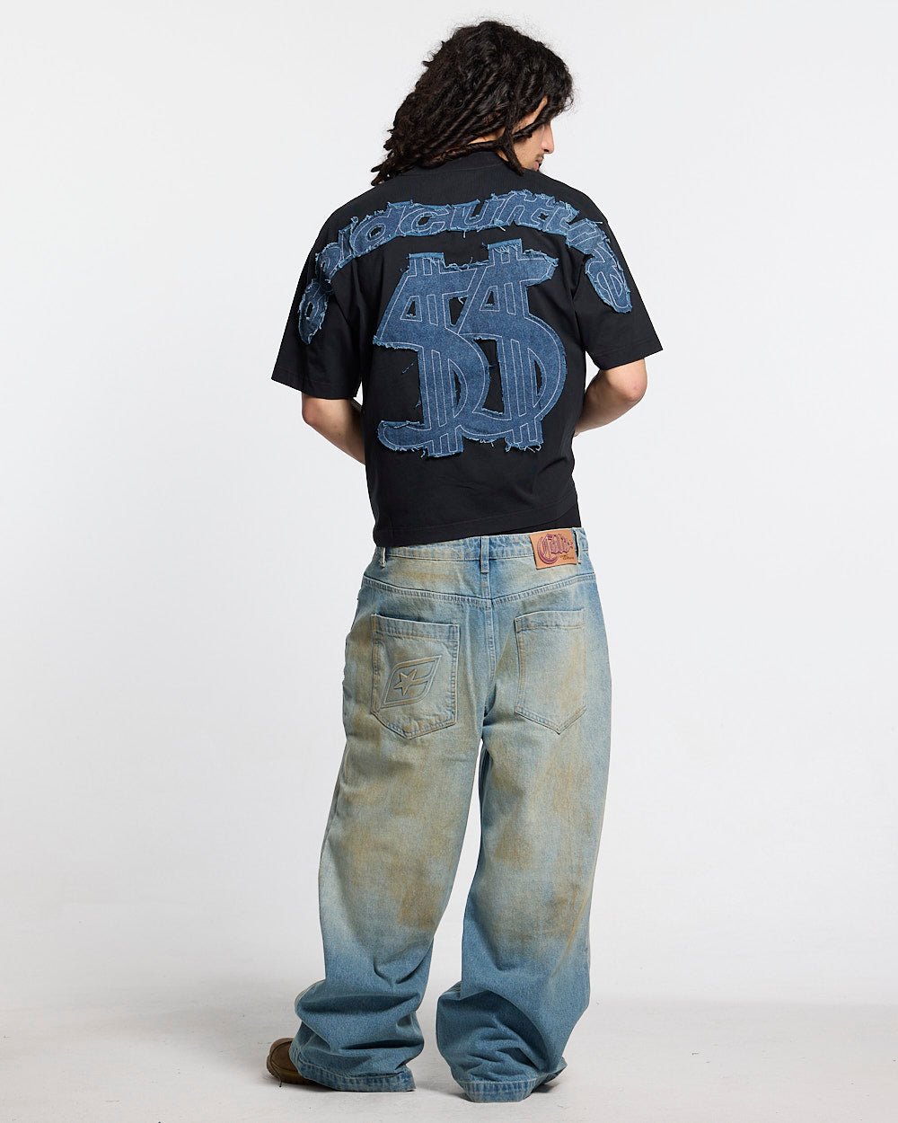 DISTRESSED DOLLAR TEE BLACK - black tee with denim applique, back view on male model - Cold Culture #man