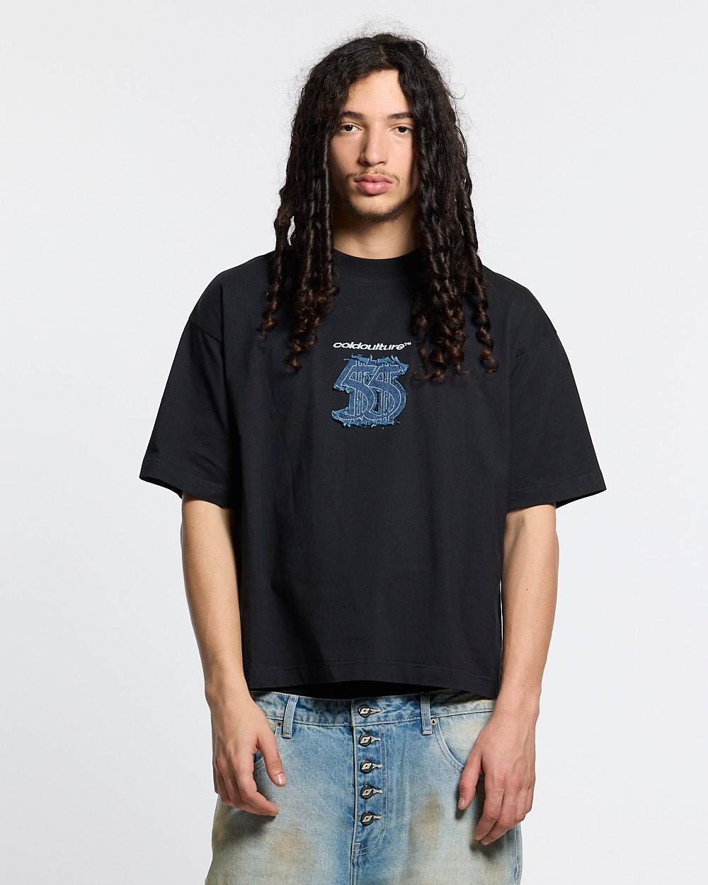 DISTRESSED DOLLAR TEE BLACK - black tee with denim applique, front view on male model - Cold Culture #man