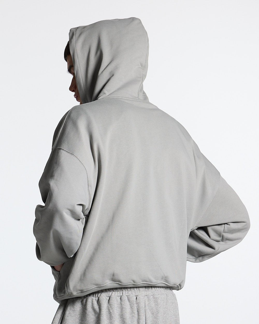 ESSENTIAL HOODIE ULTIMATE GREY - light grey oversized hoodie, back view on male model - Cold Culture