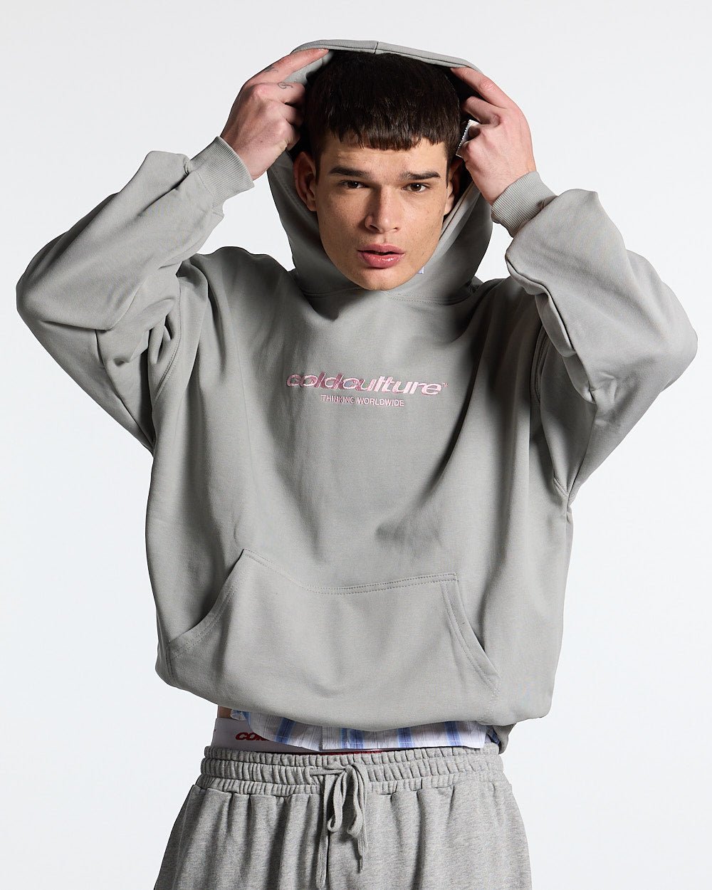 ESSENTIAL HOODIE ULTIMATE GREY - light grey oversized hoodie, front view on male model - Cold Culture #man