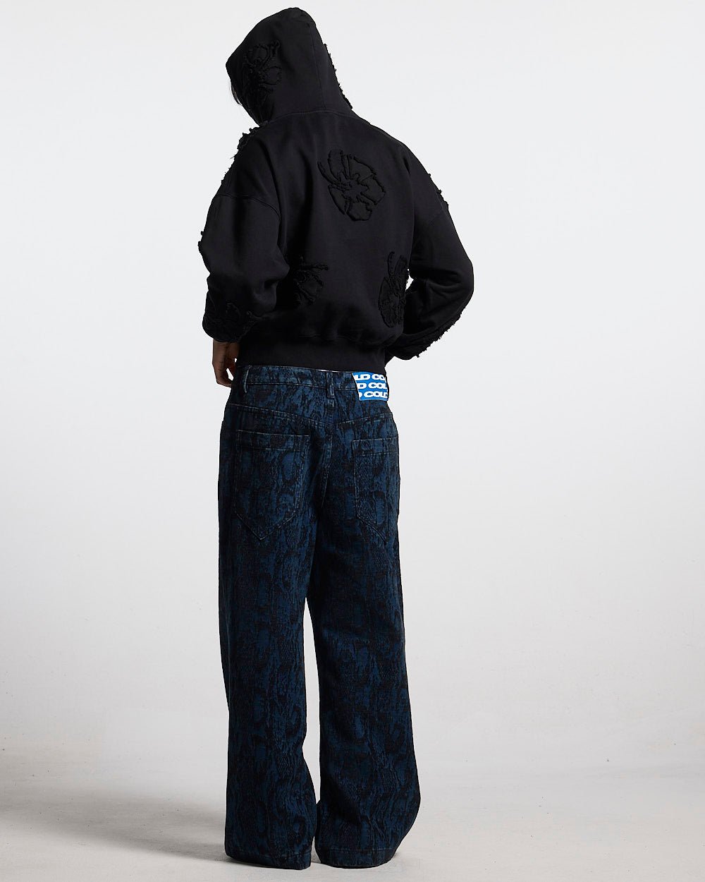 FAKE LOVE HOODIE BLACK - black floral applique hoodie, back view on female model - Cold Culture #woman