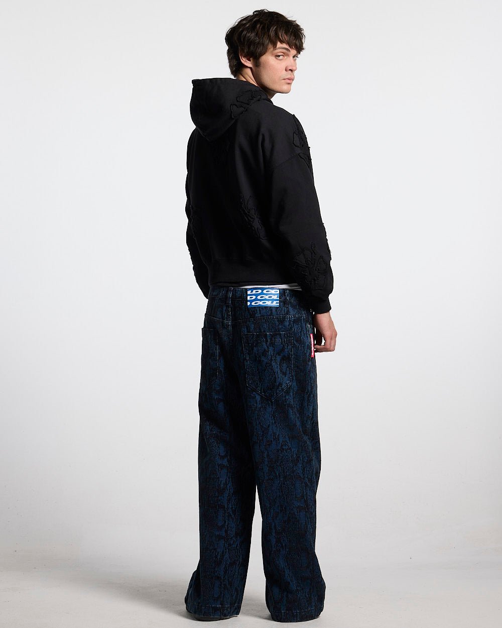 FAKE LOVE HOODIE BLACK - black floral applique hoodie, back view on male model - Cold Culture