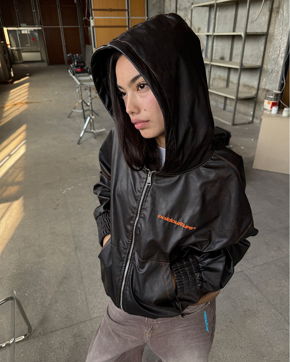 FAUX LEATHER ZIP HOODIE BROWN - brown faux leather hooded jacket, on model close-up - Cold Culture