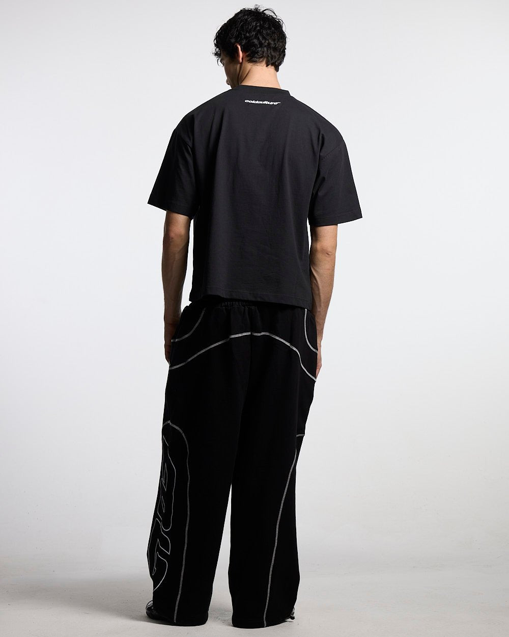 FEISTY TEE BLACK - black graphic print tee, back view on male model - Cold Culture #man