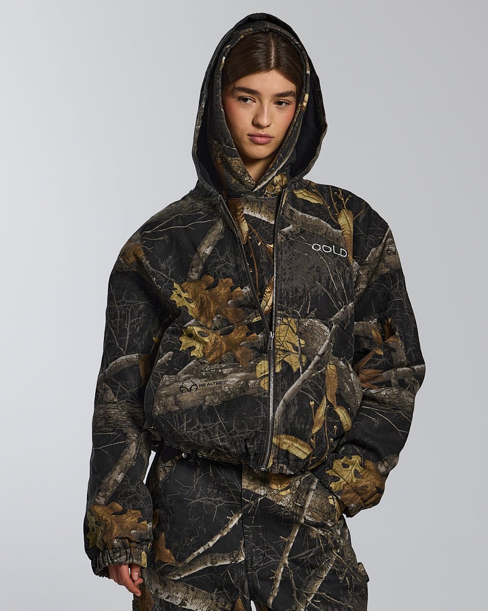 HOODED JACKET REALTREE BLACK - black realtree camo hooded jacket, front view on female model - Cold Culture #woman