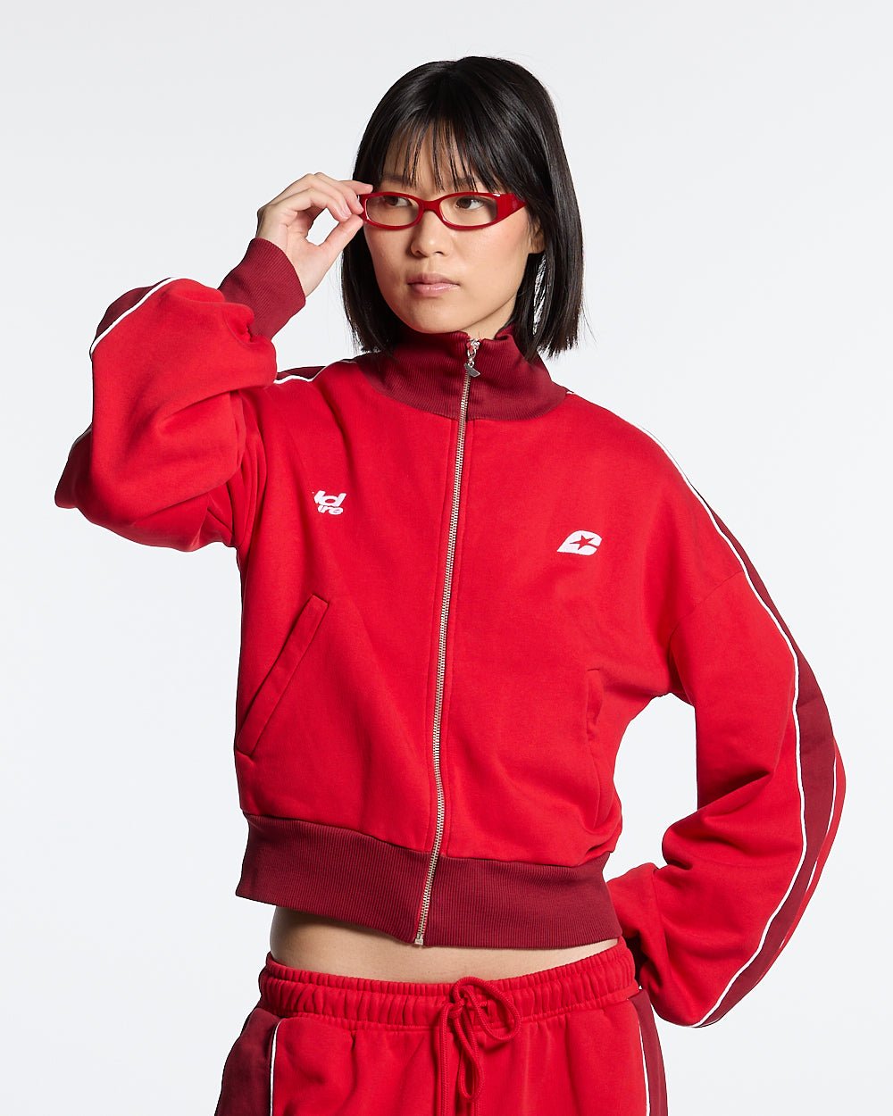 JET LAG JACKET RED - red and burgundy zip-up hoodie, front view on female model - Cold Culture #woman