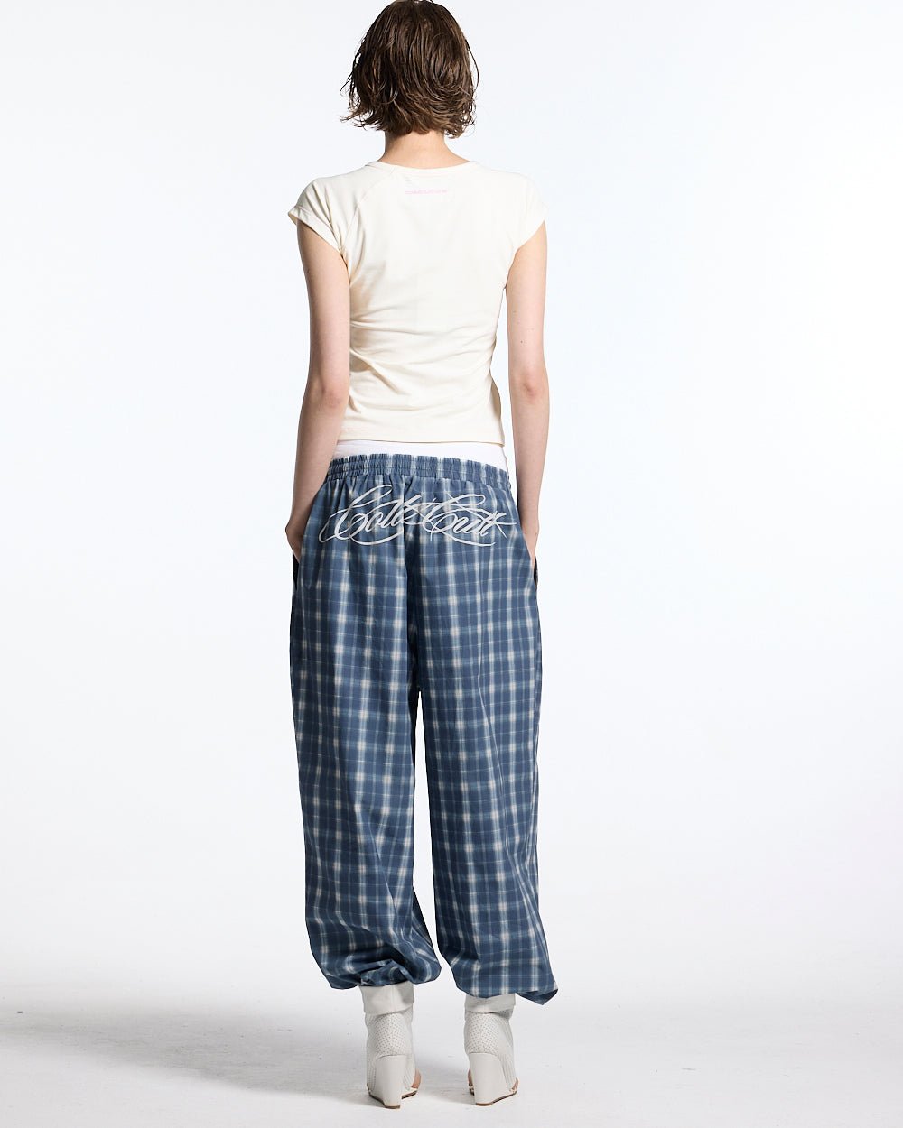 LITTLE BABY TEE WHITE - off-white graphic baby tee, back view on female model - Cold Culture #woman