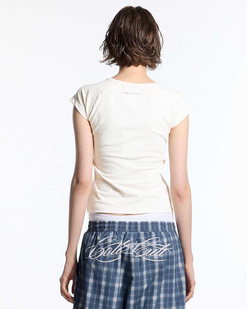 LITTLE BABY TEE WHITE - off-white graphic baby tee, back view on female model - Cold Culture #woman