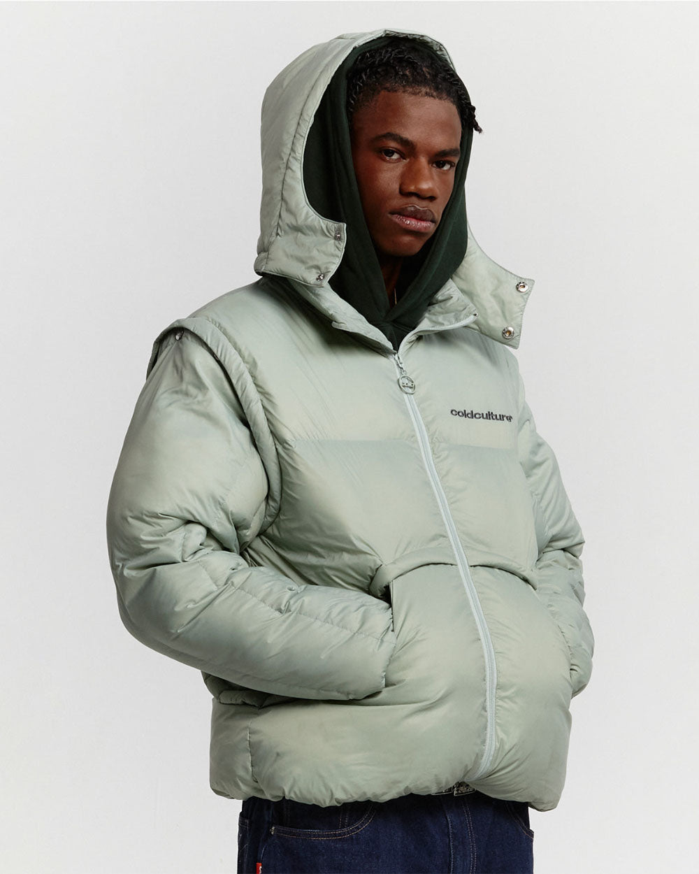 MULTIFUNCTIONAL PUFFER JACKET PISTACHIO GREEN - pistachio green hooded puffer jacket, front view on male model - Cold Culture #man