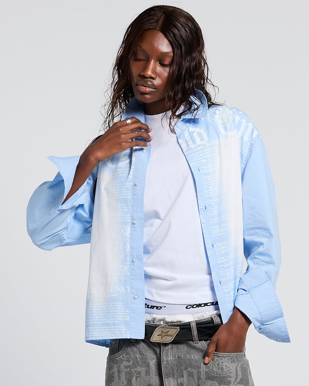 NEWSPAPER LONGSLEEVE SHIRT BABY BLUE - baby blue newspaper print shirt, front view on female model - Cold Culture #woman
