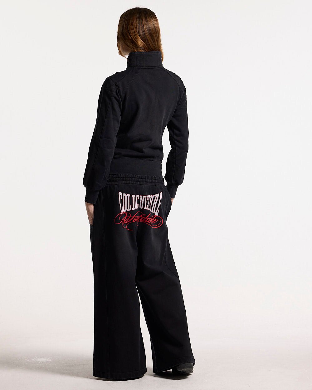 NIA SET ZIP UP BLACK - black graphic print zip-up hoodie, back view on female model - Cold Culture #woman