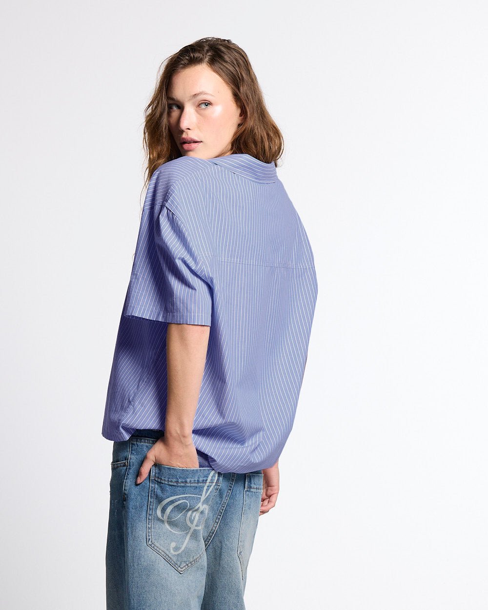 OFFICE SCRIPT SHIRT BLUE - blue striped short sleeve shirt, back view on female model - Cold Culture #woman