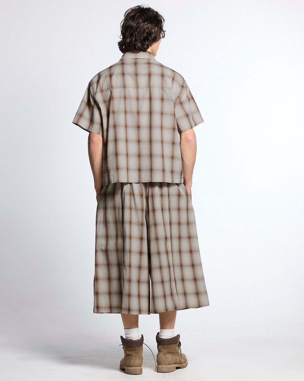 OFFICE SCRIPT SHORTS BEIGE - beige plaid wide leg shorts, back view on male model - Cold Culture #man