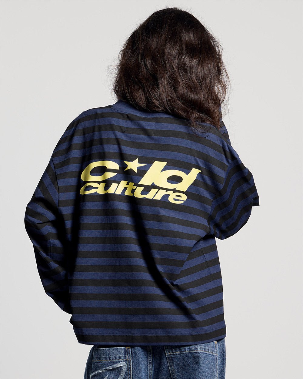PARDON ME LONGSLEEVE BLACK & BLUE - black and blue striped longsleeve tee, back view on female model - Cold Culture #woman