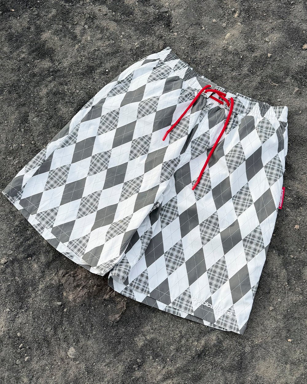 PREPPY SWIMSHORTS WHITE - white argyle swim shorts, flat lay - Cold Culture