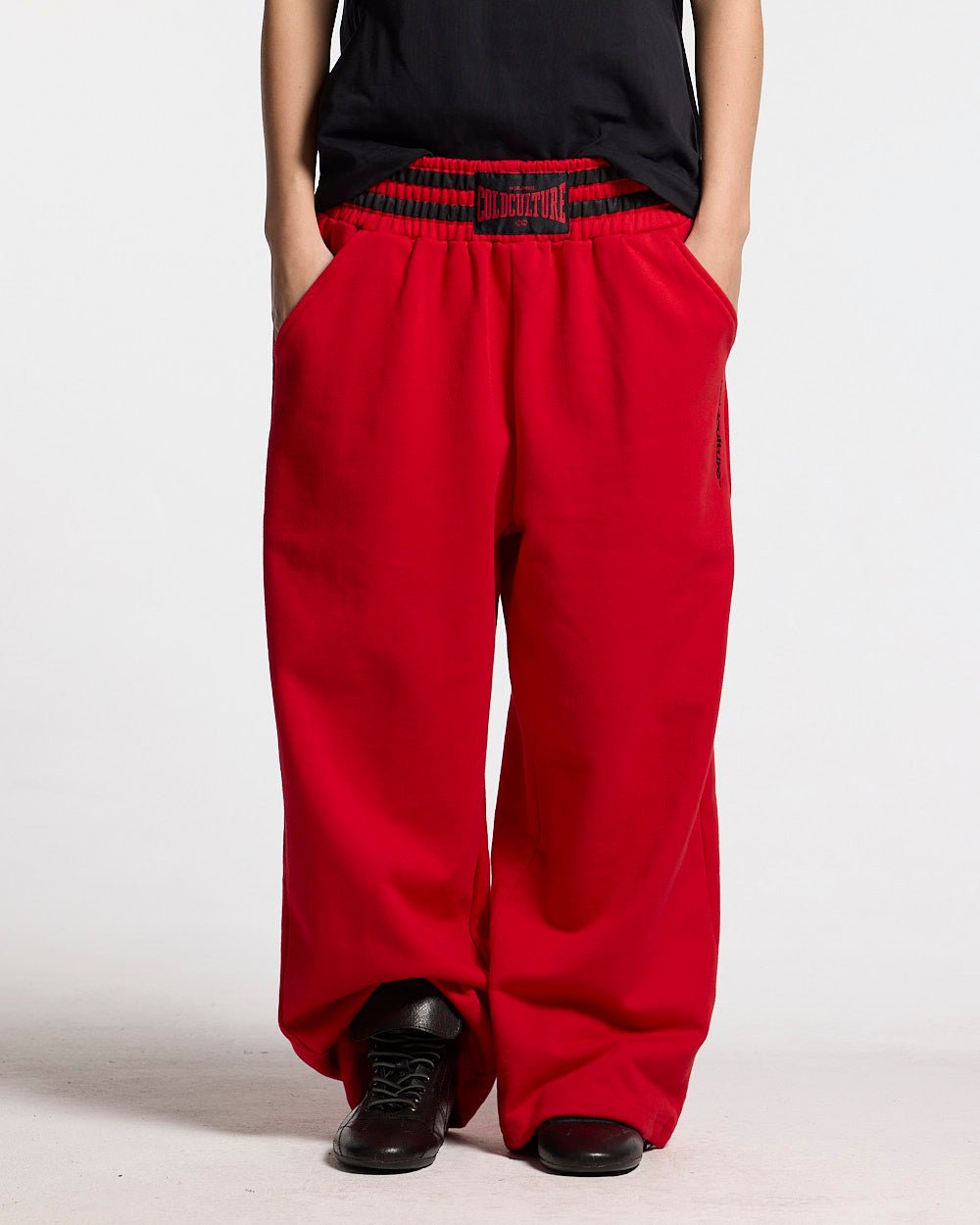 RAGE IN THE RING PANTS RED - red baggy sweatpants, front view on female model - Cold Culture #woman
