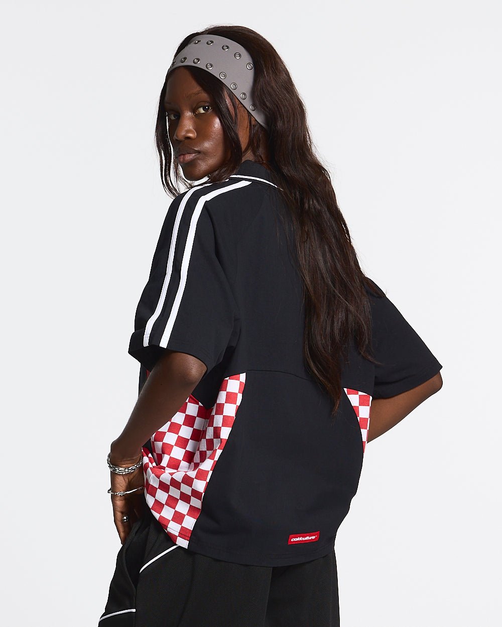 RED CHESS POLO TSHIRT BLACK - black checkered polo shirt, back view on female model - Cold Culture #woman