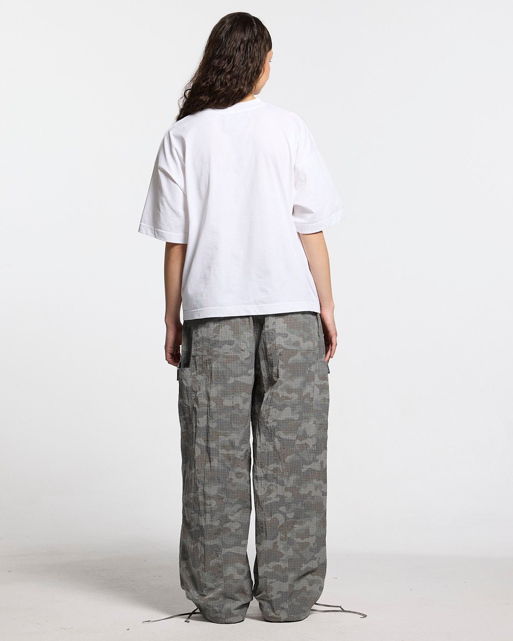 RESERVED CARGO PANTS CAMO - grey camo cargo pants, back view on female model - Cold Culture #woman