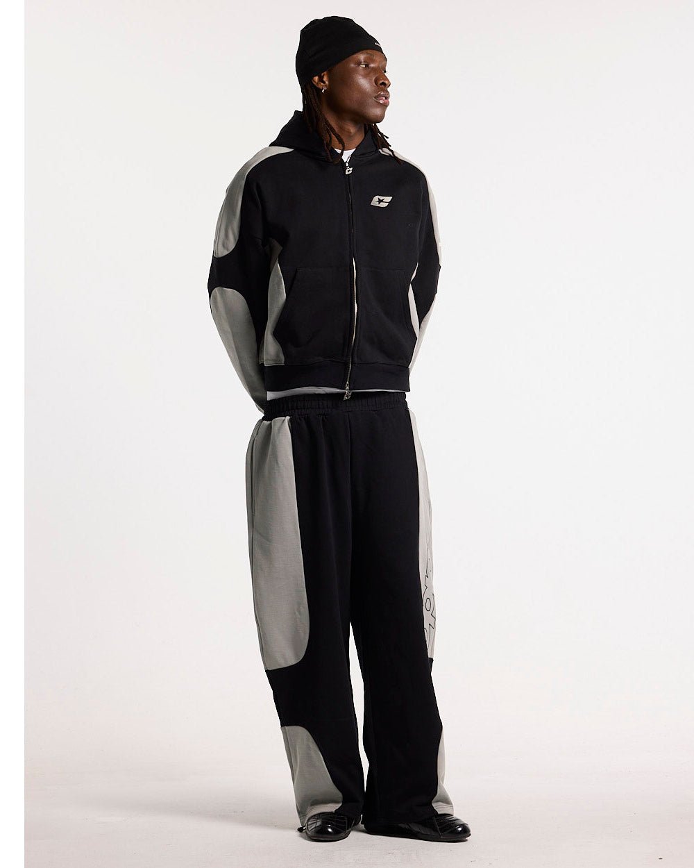 RIDER SWEATPANTS BLACK & GREY - black and grey paneled sweatpants, front view on male model - Cold Culture #man