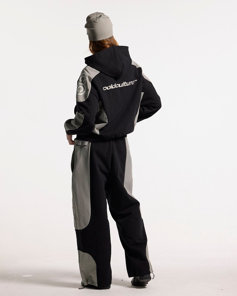 RIDER SWEATPANTS BLACK & GREY - black and grey paneled sweatpants, back view on female model - Cold Culture #woman